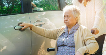 Asian senior or elderly old lady woman patient sitting on wheelchair prepare get to her car : healthy strong medical concept.